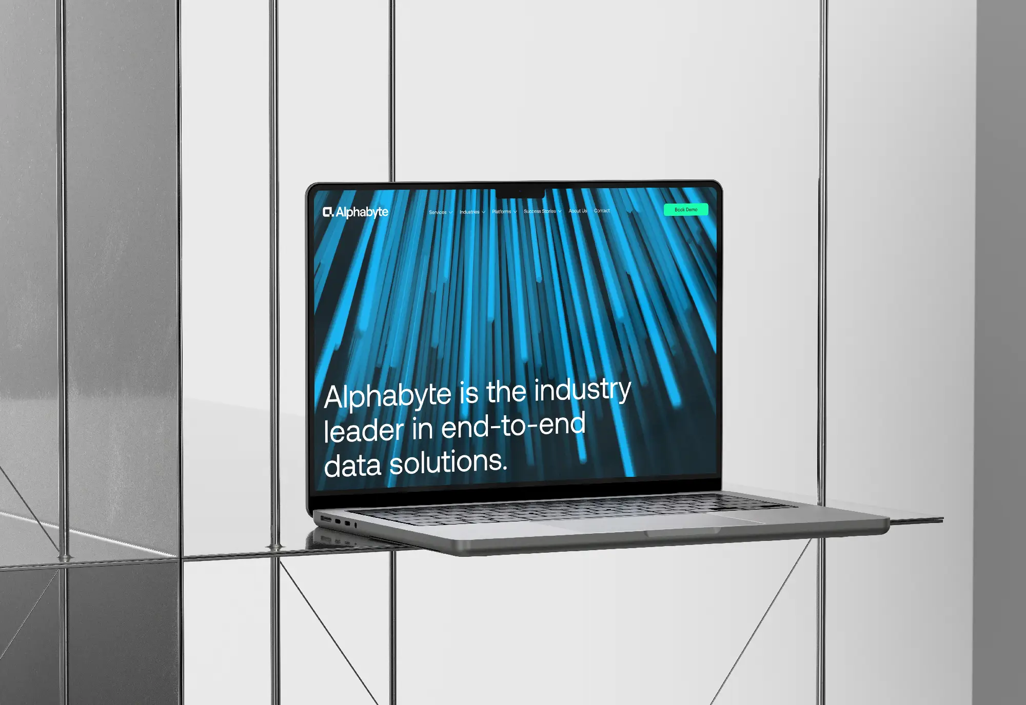 laptop with alphabyte home page sitting on glass shelving