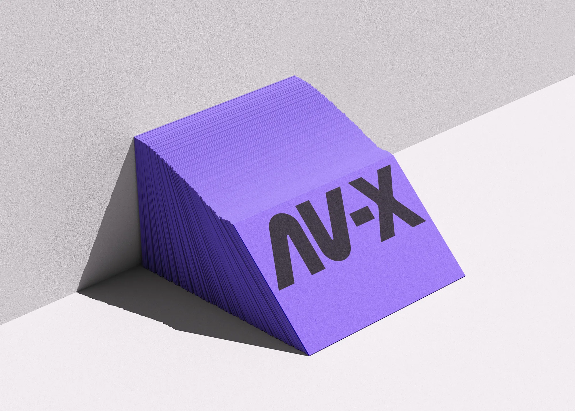 side stack of av-x busniess cards, showing the logo on the front