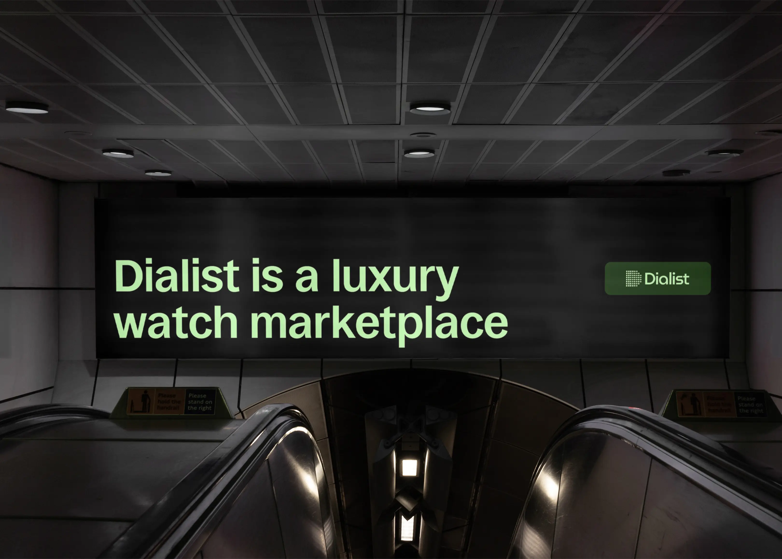 dialist billboard above subway escalator
