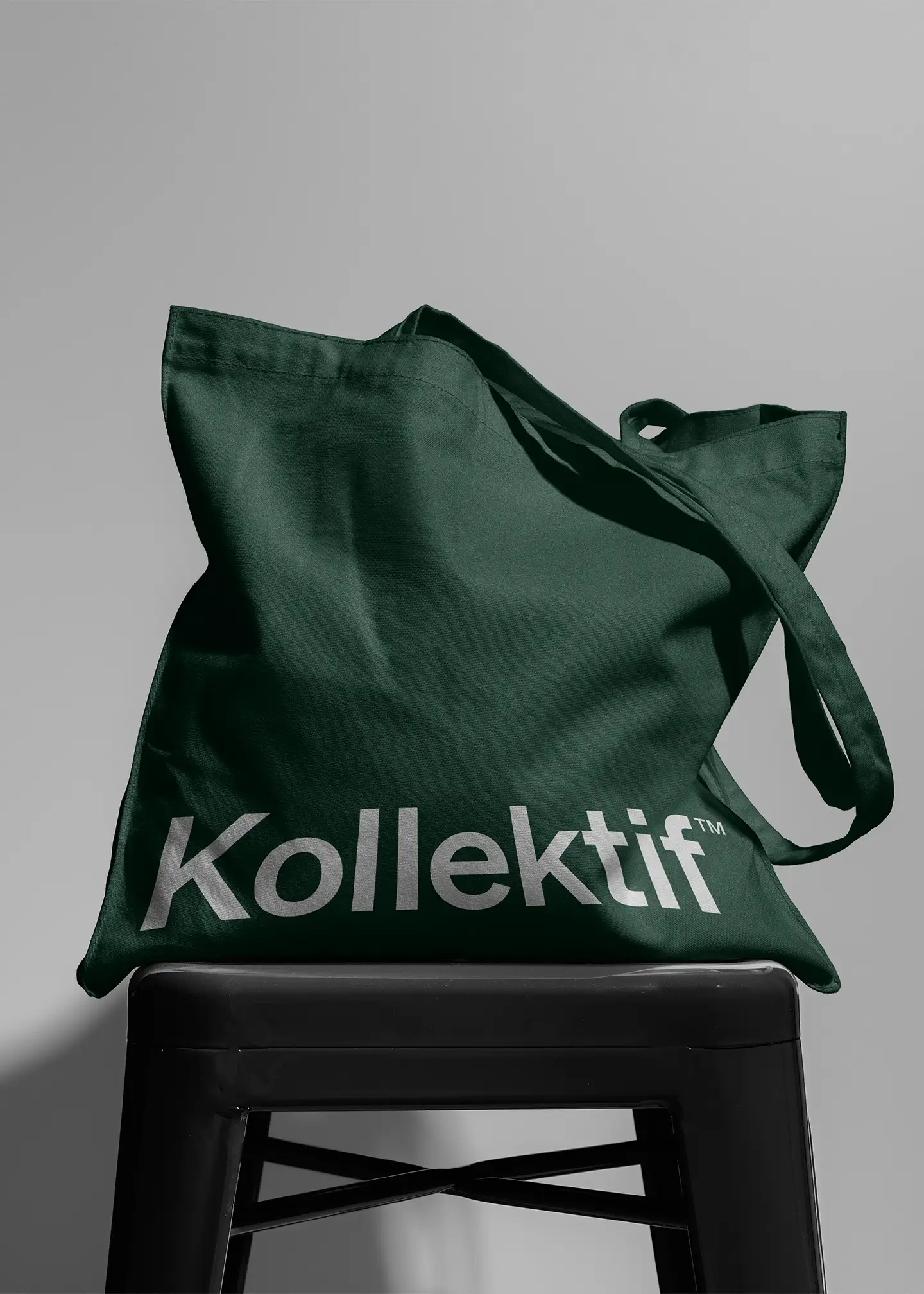 kollektif green tote bag on stool