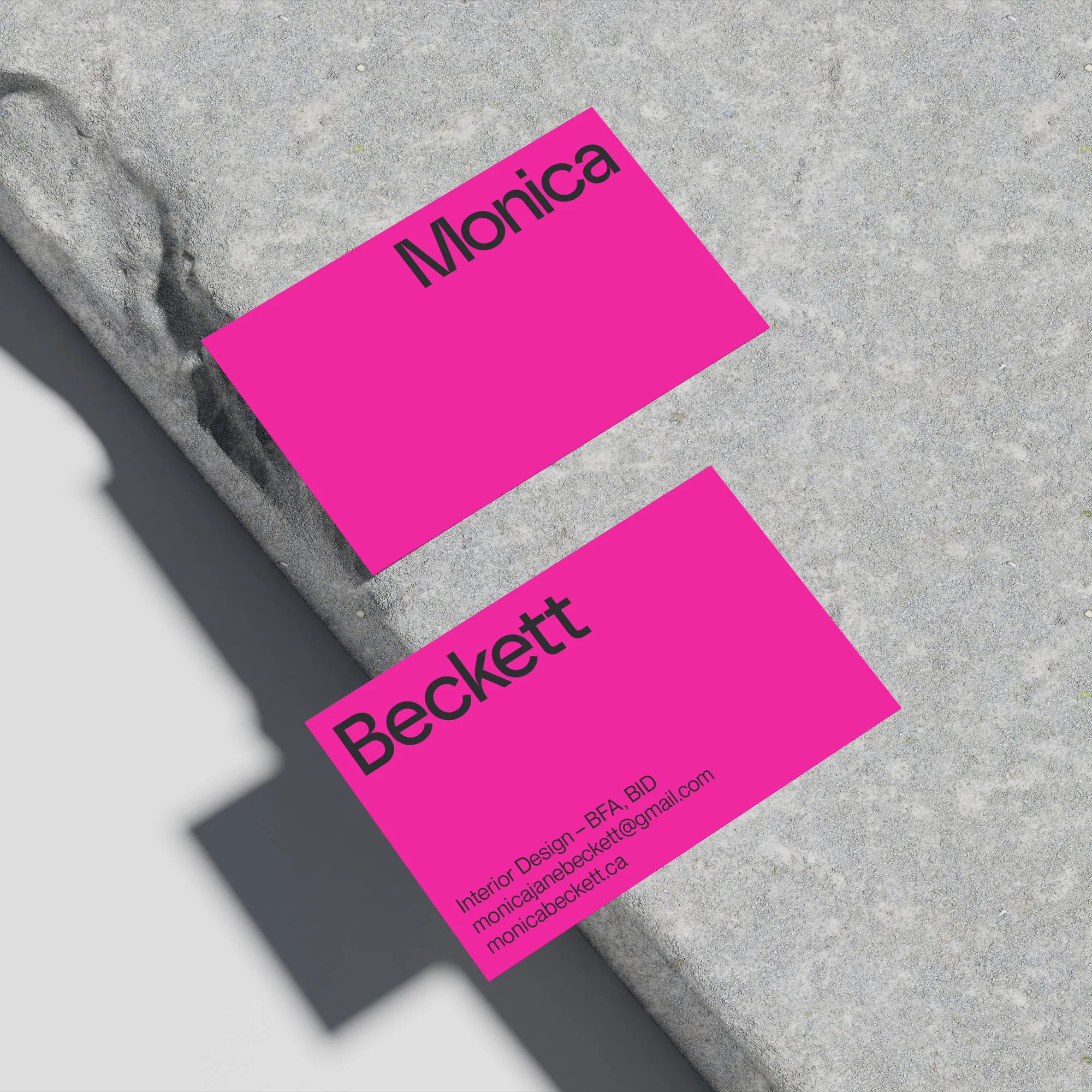  pink business cards on grey stone 
